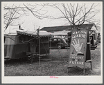 Fortune teller's sign and trailer near trailer camps where Army men and construction workers live on highway near Fort Benning, Columbus, Georgia.