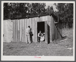 Construction workers from Monroe, Louisiana, washing in front of their shack. Water must be hauled from a nearby church faucet. They are living on government property (no rent) while working at Camp Livingston near Fort Beauregard, Alexandria, Louisiana.