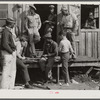 Migratory laborers playing checkers in front of juke joint during slack season for vegetable pickers. Belle Glade, Florida.