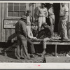 Migratory laborers playing checkers in front of juke joint during slack season for vegetable pickers. Belle Glade, Florida.