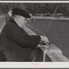 Guest of Sarasota trailer park, Sarasota, Florida, with fish bait, fishing from bridge.