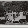 Relaxing outside their trailer home, Sarasota trailer park, Sarasota, Florida.
