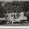 Relaxing outside their trailer home, Sarasota trailer park, Sarasota, Florida.