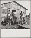 Migratory laborers playing checkers in front of jook joint during slack season for vegetable pickers. Belle Glade, Florida.