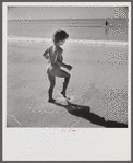 Daughter of parents living at Sarasota trailer park, Sarasota, Florida, playing in the water at the beach.