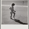 Daughter of parents living at Sarasota trailer park, Sarasota, Florida, playing in the water at the beach.