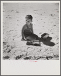 Son of parents who live at Sarasota trailer park, Sarasota, Florida, playing on the beach.