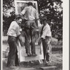 Testing a home-made screen door for strength. Screening demonstration. Charles County, La Plata, Maryland.