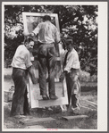 Testing a home-made screen door for strength. Screening demonstration. Charles County, La Plata, Maryland.