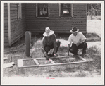 Fastening the stock with corrugated staples. Screen door construction. Charles County, La Plata, Maryland.