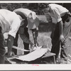 Galvanized sheet steel of 24 gauge is used as corner reinforcement. Screen door construction demonstration. Charles County, La Plata, Maryland.