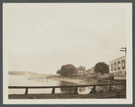 View of west shore of Greenport Harbor, showing wharfs and Shelter Island in the distance. Greenport, Southold
