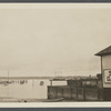 View of Greenport Harbor, showing wharves, boats, and Shelter Island in the distance. Greenport, Southold