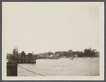 View of Greenport Harbor from ferry, showing wharves and houses on shore. Greenport, Southold