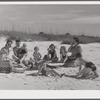 Guests of Sarasota trailer park, Sarasota, Florida, picnicking at the beach with their family and neighbor's children.