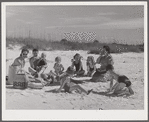 Guests of Sarasota trailer park, Sarasota, Florida, picnicking at the beach with their family and neighbor's children.