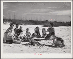 Guests of Sarasota trailer park, Sarasota, Florida, picnicking at the beach with their family and neighbor's children.
