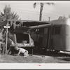 One of the guests at Sarasota trailer park, Sarasota, Florida, washing his car. He has named his trailer home "Loveless".