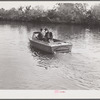 Three FSA (Farm Security Administration) supervisors going out the bayous and marshes to some of the muskrat trappers at their camps. Near Delacroix Island, Louisiana.