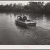 Three FSA (Farm Security Administration) supervisors going out the bayous and marshes to some of the muskrat trappers at their camps. Near Delacroix Island, Louisiana.