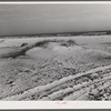 Sand dunes and water in gulf along highway near Pensacola, Florida.