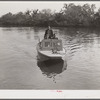 Three FSA (Farm Security Administration) supervisors going out in the bayous and marshes to visit some of the muskrat trappers at their camp. Near Delacroix Island, Louisiana. See general caption number one.