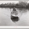 Three FSA (Farm Security Administration) supervisors going out in the bayous and marshes to visit some of the muskrat trappers at their camp. Near Delacroix Island, Louisiana. See general caption number one.