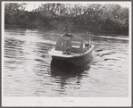 Weldon P. Smith, FSA (Farm Security Administration) supervisor, going out to the bayous and marshes to visit some of the muskrat trappers at their camps. Near Delacroix Island, Louisiana. See general caption number one.