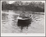 Weldon P. Smith, FSA (Farm Security Administration) supervisor, going out to the bayous and marshes to visit some of the muskrat trappers at their camps. Near Delacroix Island, Louisiana. See general caption number one.