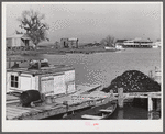 Trappers' and fishermen's boats and homes along the bayou. Delacroix Island, Louisiana.