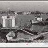 Trappers' and fishermen's boats and homes along the bayou. Delacroix Island, Louisiana.