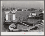 Trappers' and fishermen's boats and homes along the bayou. Delacroix Island, Louisiana.