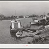 Trappers' and fishermen's boats and homes along the bayou. Delacroix Island, Louisiana.