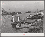Trappers' and fishermen's boats and homes along the bayou. Delacroix Island, Louisiana.