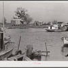 Trappers' and fishermen's boats and homes along the bayou. Delacroix Island, Louisiana.