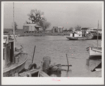 Trappers' and fishermen's boats and homes along the bayou. Delacroix Island, Louisiana.