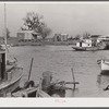 Trappers' and fishermen's boats and homes along the bayou. Delacroix Island, Louisiana.