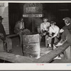 Negro laborers sitting around in front of a fire on Saturday night in a street of the Negro quarter of Belle Glade, Florida.