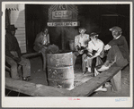 Negro laborers sitting around in front of a fire on Saturday night in a street of the Negro quarter of Belle Glade, Florida.