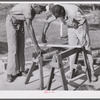 Measuring the top piece. Demonstration of home screen door construction. Saint Mary's County, Ridge, Maryland.