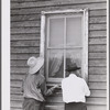 The window is screened except for nailing the last window strip. Screening demonstration. Charles County, La Plata, Maryland.