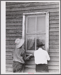 The window is screened except for nailing the last window strip. Screening demonstration. Charles County, La Plata, Maryland.