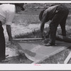 Assembling screen wire battens for covering window frames. Screening demonstration. Charles County, La Plata, Maryland.