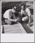Nailing a joint of screen door. These doors are simple to build, require few tools, are durable and inexpensive. Screening demonstration. Saint Mary's County, Ridge, Maryland.