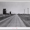 Grain storage elevators and highway through Lone Tree, North Dakota.