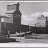 Loading freight on to wagon from station platform as the freight train is leaving Homestead, Montana.