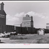 Loading freight on to wagon from station platform as the freight train is leaving Homestead, Montana.