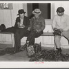 Fur buyers figuring out their bid for trapper's muskrats at auction sale in dance hall. Delacroix Island, Louisiana.