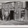 Living quarters, store, and "juke joint" for migratory laborers near Canal Point, Florida.