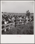 Spectators at paddock fence between races. Warrenton, Virginia.